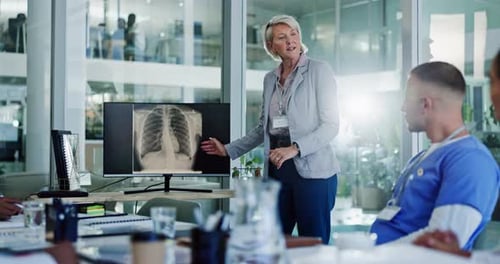 Medical Team Discussing X-Ray in Modern Office