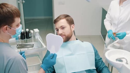 Happy Patient Admiring Smile After Dental Visit