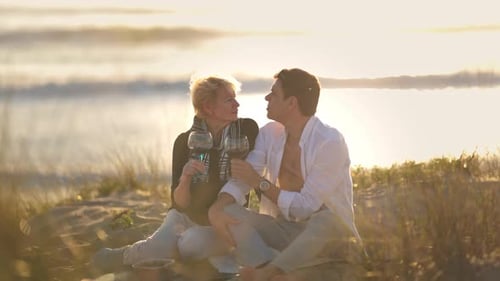 Romantic Couple Drinking Red Wine at Sunset