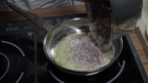 Adding onion to the meat sauce mixture, coffee in paris butter. Hot pan on induction stove