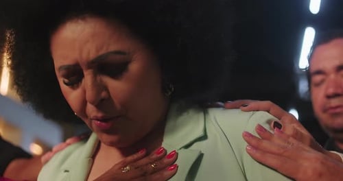 Woman Receives Comforting Support with Hands on Shoulders