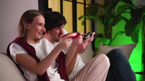 Happy Couple Playing Video Game at Home Together