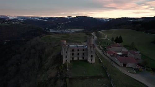 Aerial drone shot of Essalois Castle in the Gorges de la Loire near Saint Etienne at sunset, Loire d