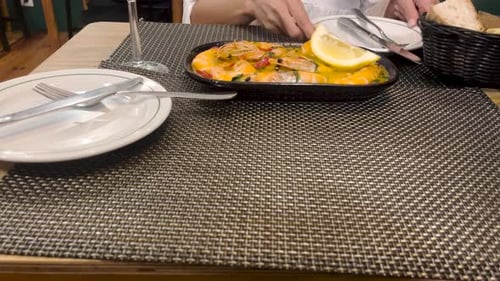 Serving Fresh Seafood Dish in Cozy Restaurant Setting