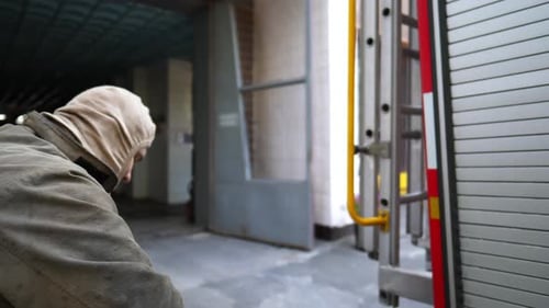 Firefighter Prepares Gear at Urban Fire Station