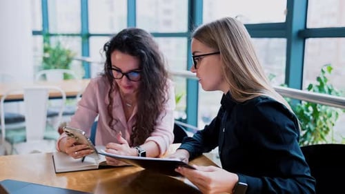 Women Discussing Business at Modern Workplace