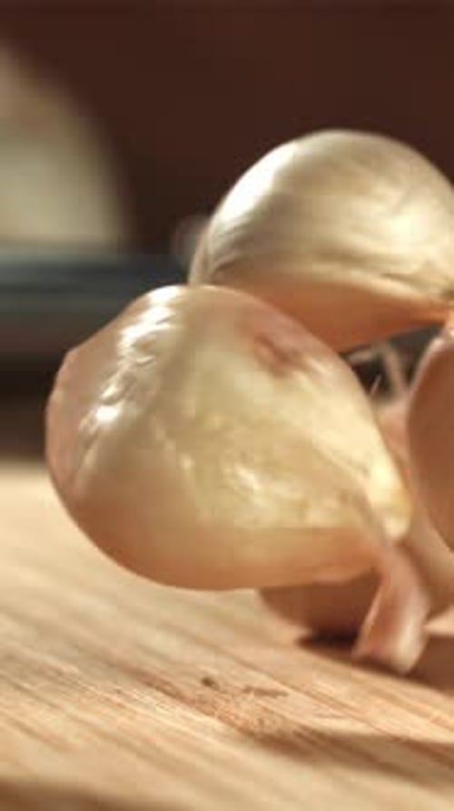 Fresh Garlic Falls on a Cutting Board Filmed on a Highspeed Camera at 1000 Fps