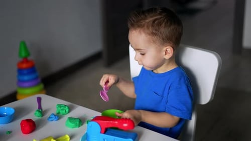 Cute Child Playing with Clay Indoors