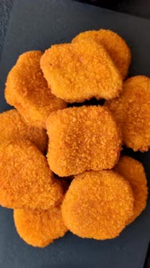 Fried chicken nuggets with sauce, salt, and spices, fast food, unhealthy food. Chicken nuggets