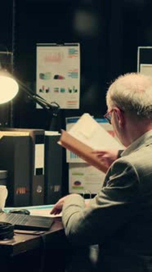 Man and Woman Reviewing Documents in Office