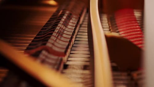 Close-Up of Piano Mechanics - Moving Strings and Hammers During Play, Warm Light