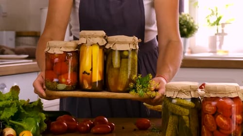 A Woman is Preserving Vegetables in the Kitchen Selective Focus