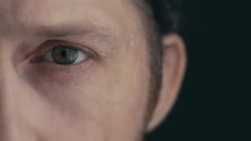 Close-Up of a Man's Eye on Dark Background