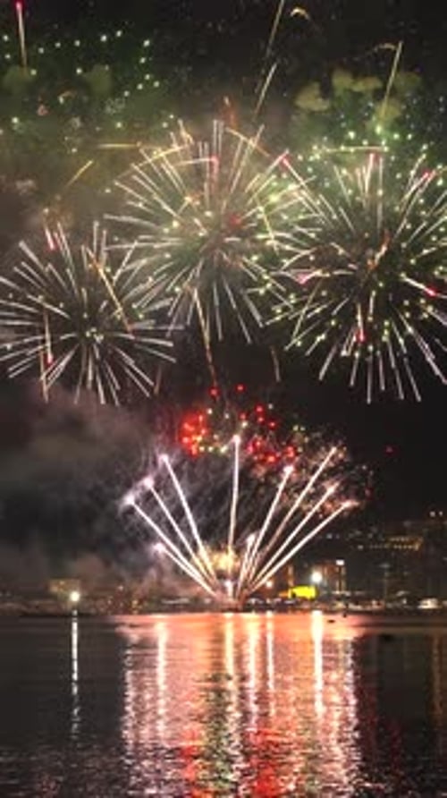 Fireworks with colorful lights over sea