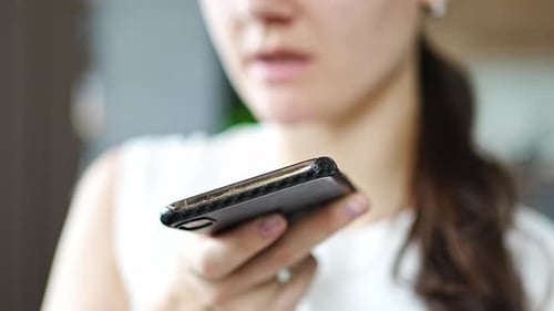 Young Woman Recording a Voice Message on Phone