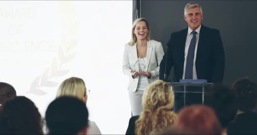 Cheerful businessman delivering a speech during an award ceremony at a corporate business
