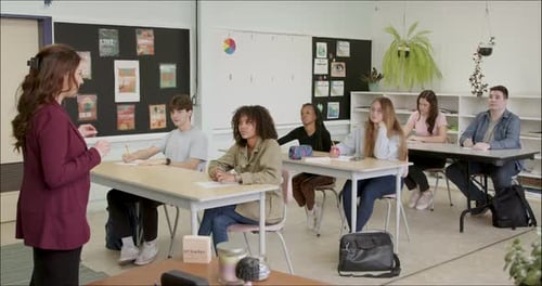 Student Learning in School Class Room. High School or College Class Raising Hand Asking Question