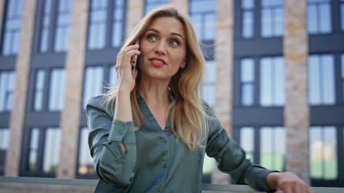 Woman Talking on Cell Phone Outside Urban Building