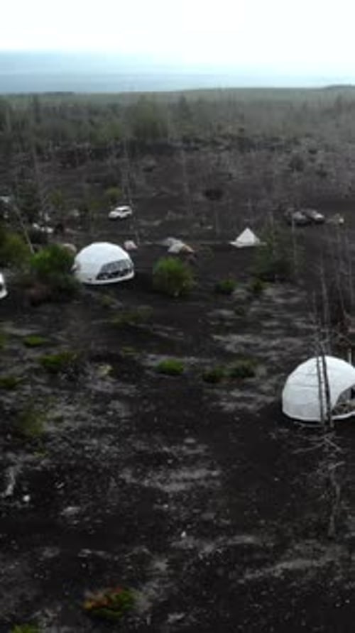 Aerial View of Glamping Domes in Volcanic Landscape Media