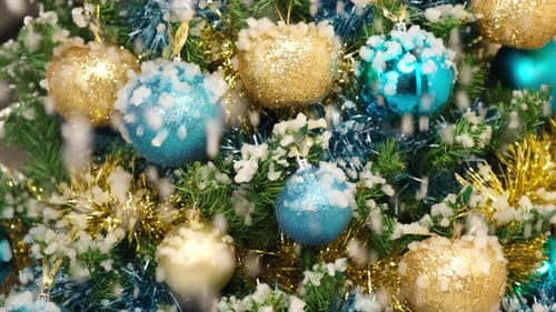 Close Up of Christmas Tree with Snow Falling