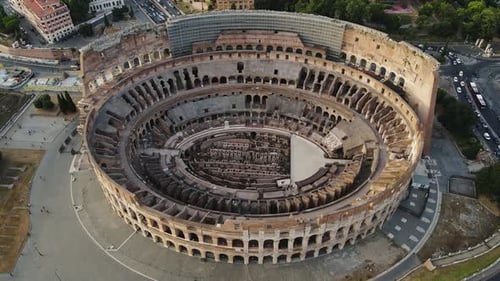 Majestic Aerial View of the Colosseum, Rome at Sunset Under Dramatic Cloudy Sky