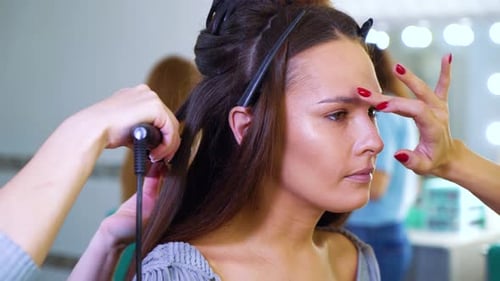 Woman Getting Hairstyle at Salon