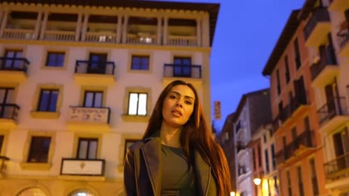 Brunette model posing at night in european city