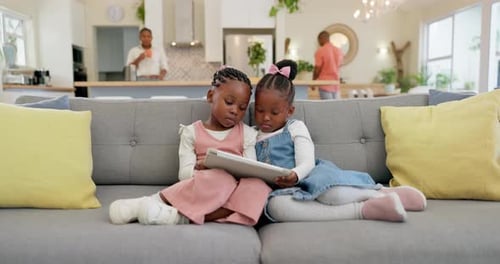 Two Young Girls Using Tablet at Home