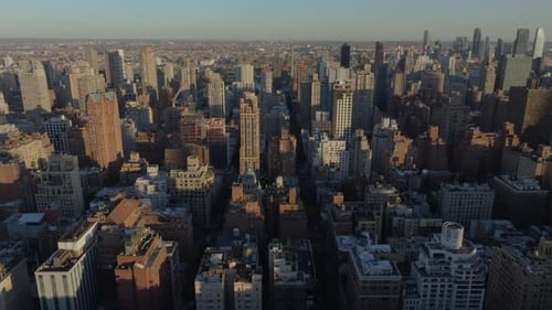 Aerial Views Showcase the Sun Illuminating Midtown Manhattan Buildings at Sunset Highlighting
