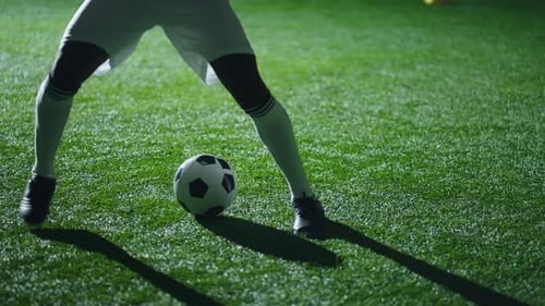 Legs of Footballer with Ball During Training Closeup View Male Feet in Boots and Gaiters