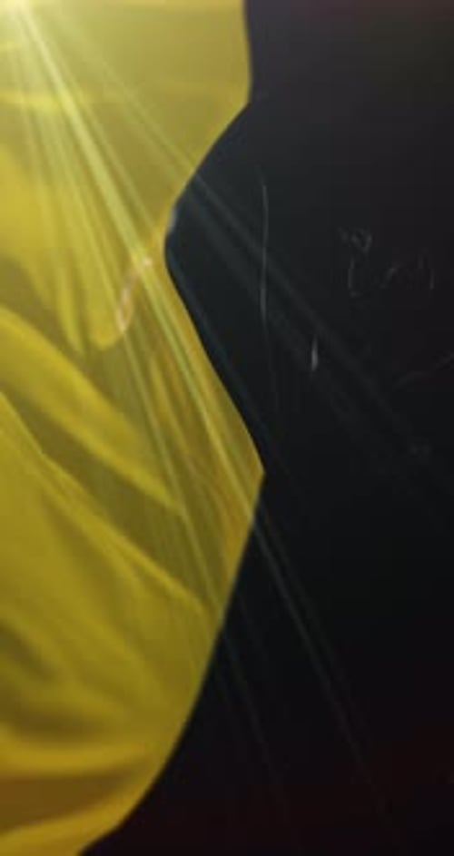 Abstract Yellow Fluid Fabric Motion Background with Light Rays