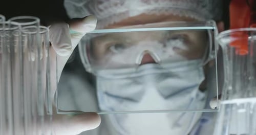 A futuristic physician, a surgeon, examines a technological digital holographic plate, a medical m
