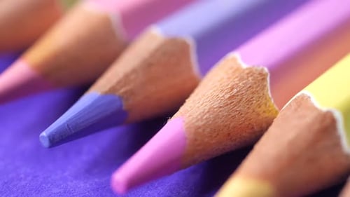Macro of Pastel Colored Pencils on Purple Paper