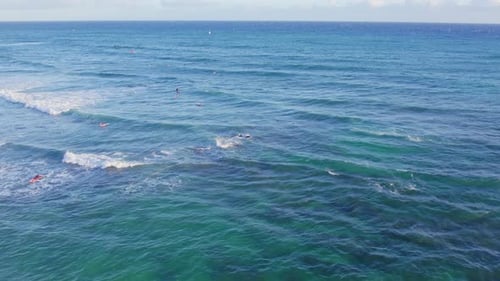 drone footage across the blue green waters of the coast of Oahu Hawaii as the white capped waves pou