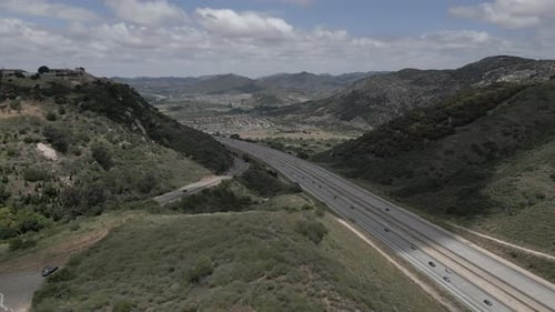 Aerial View of Highway Through Green Hills