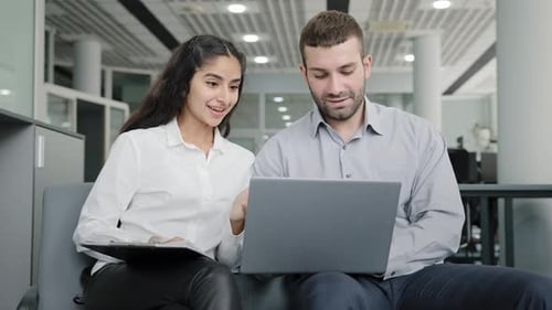 Young Man and Woman Office Workers Creative Team Colleagues Discussing Online Project Develop
