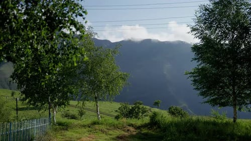 Picturesque Green Hillside Landscape With Distant Mountains