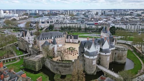 Castle of Dukes of Brittany, Nantes in France. Aerial flyback and urbanscape