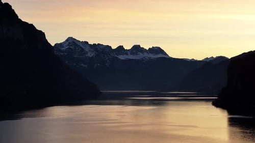 Golden dusk over Walensee, Churfirsten's silhouette. Switzerland aerial