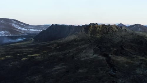 Black basalt rock surrounding dormant crater mount Geldingadalsgos in Iceland