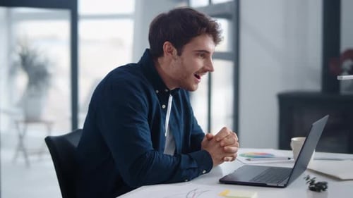 Closeup Happy Businessman Analyzing Information on Notebook in Office. Surprised Man Reading