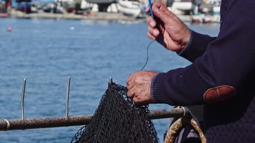 Fishermen Mending Their Torn Nets