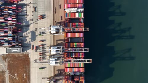 Cargo commercial port. View from a drone. Containers for transporting goods.