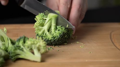 Preparing broccoli for cooking.