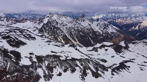 Aerial View of Snowcapped Ridges of High Mountains and Sharp Peaks