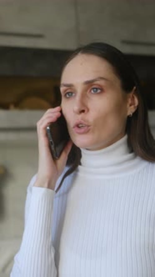Woman Talking on Mobile Phone in Home Setting