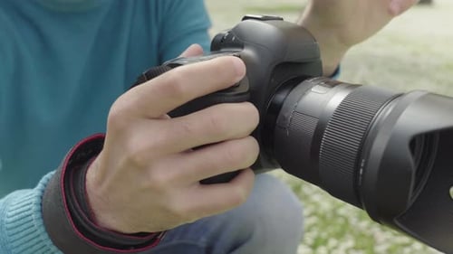 Photographer Taking Photos of Young Woman Standing in Front of a Pond