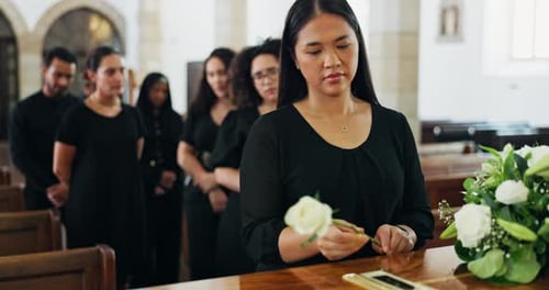 Grief, family and woman at coffin with flower at memorial service at church for respect