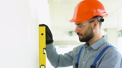 Construction Worker Checking Wall with Level