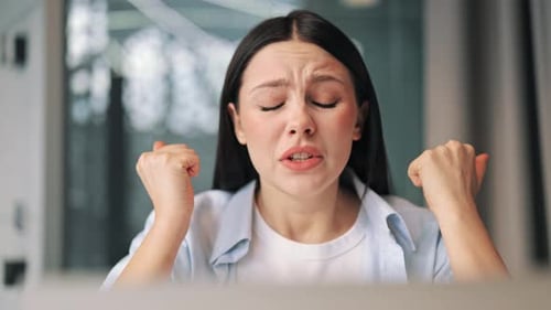 Stressed Woman Holding Head While Looking at Computer